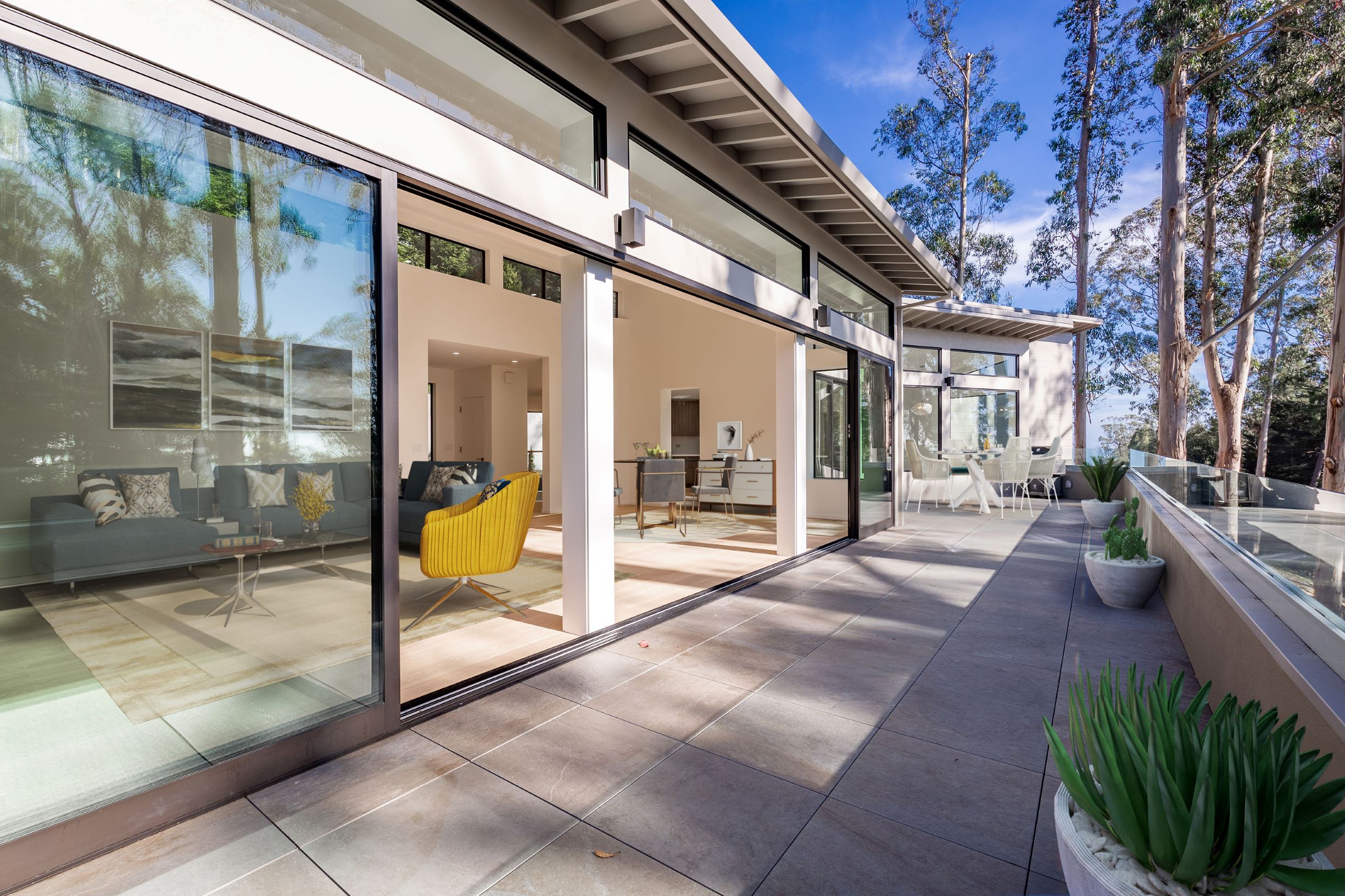 Large aluminum multi-slide doors open to patio. 
