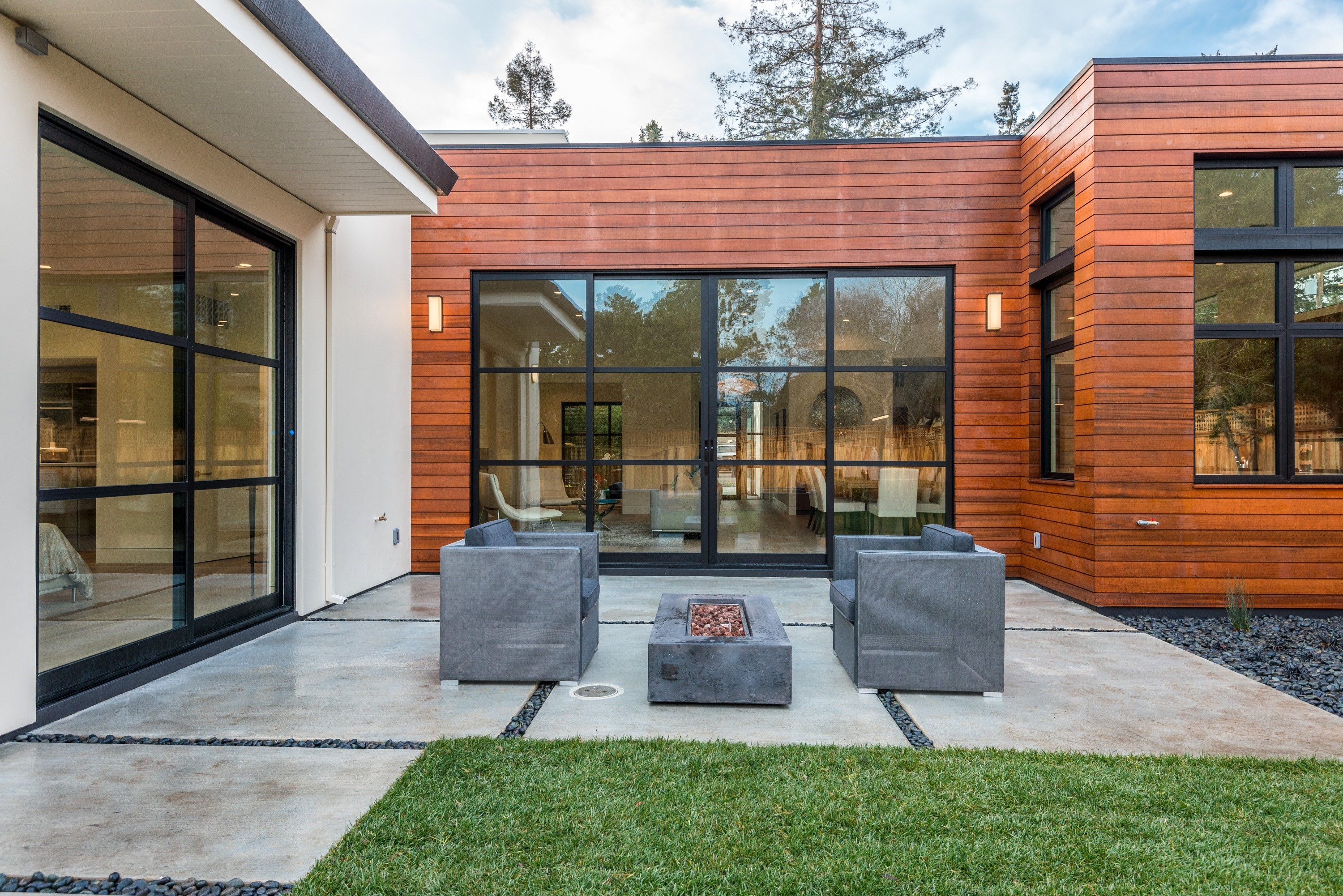 Modern back patio with sliding aluminum doors.