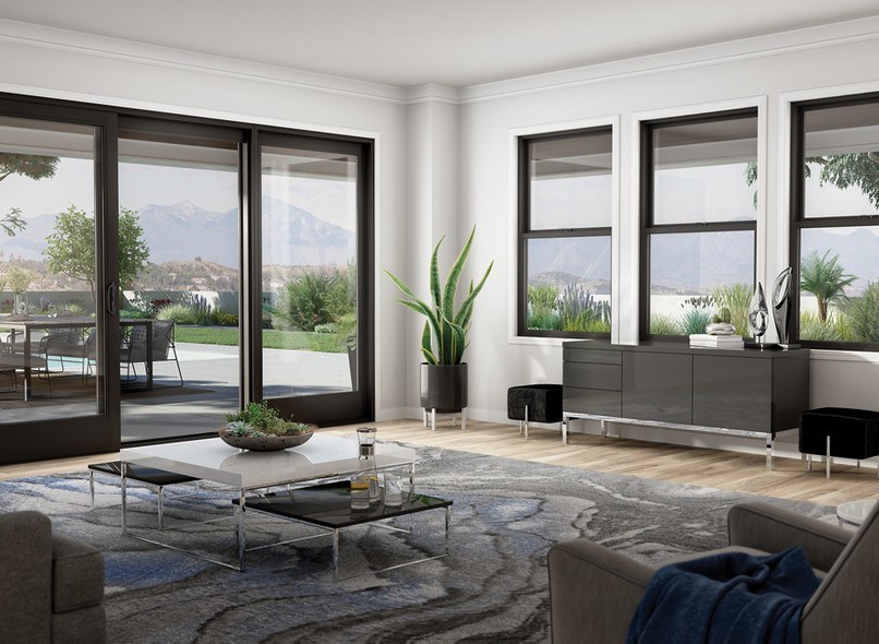 A modern style living room with a black frame Milgard Ultra C650 sliding door and three single hung windows. 