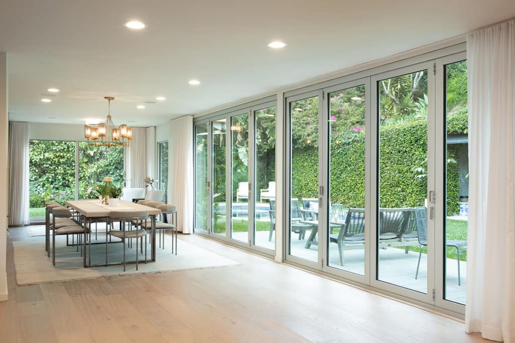 two large bi-fold door systems side by side, closed. Each door is 4 panels wide and opens in the center. 