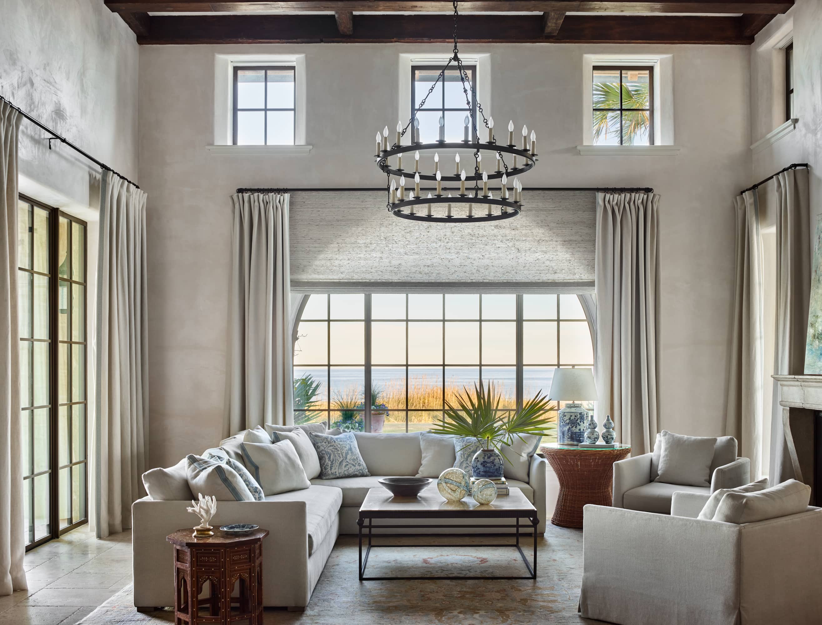 Living room with large radius window with grids.