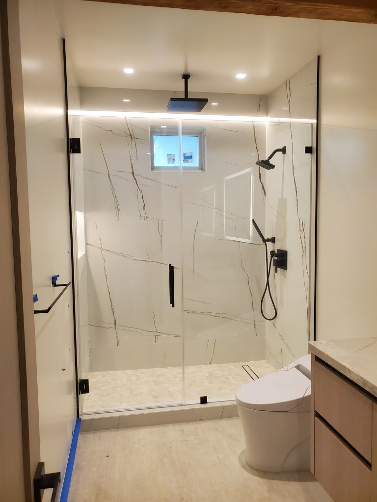 Frameless glass shower enclosure with pull door