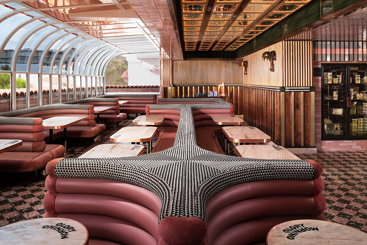 Restaurant with curved glass panel wall and ceiling. 