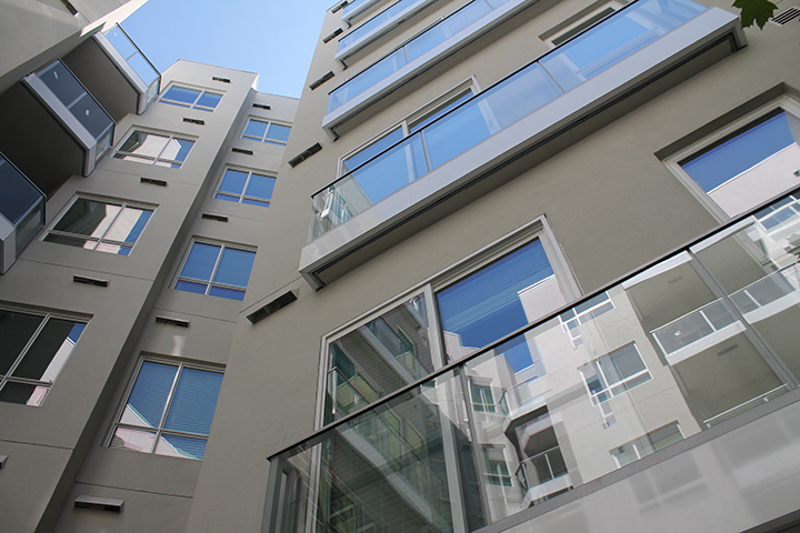 High rise building with glass balcony railings. 