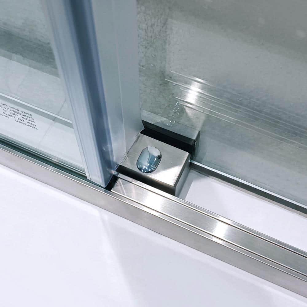 Single slide shower door bottom track showing fixed panel built in and sliding door guide in brushed nickel finish