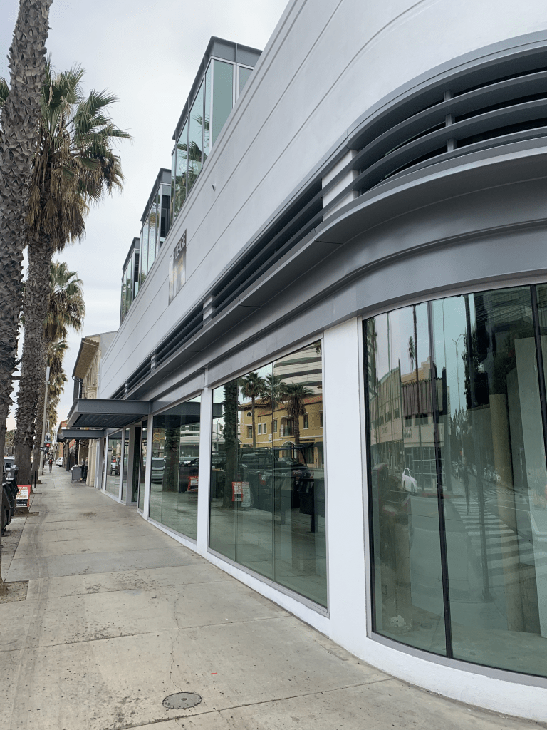 Sectioned storefront with curved glass panels
